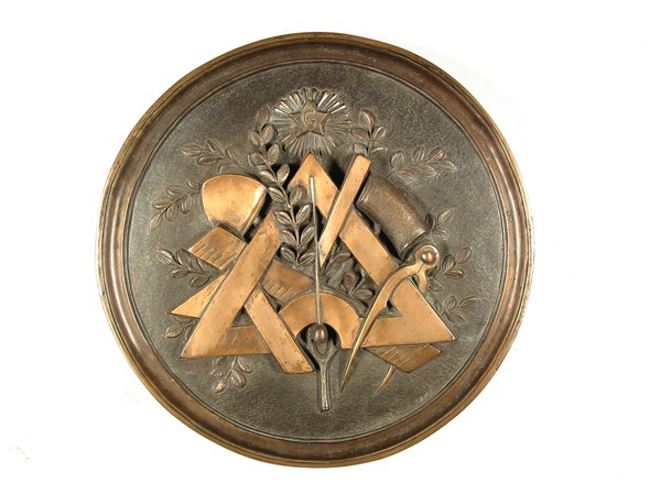Bronze medallion with a composition of working tools.