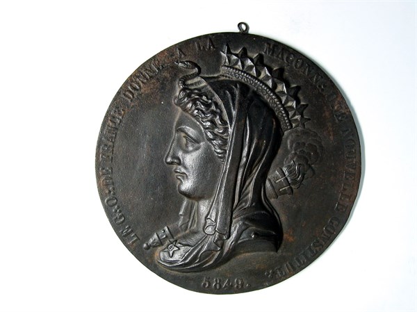 Cast-iron medallion with a female allegory in profile.