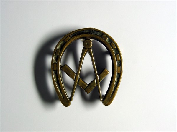 Bronze trivet in the shape of a horseshoe