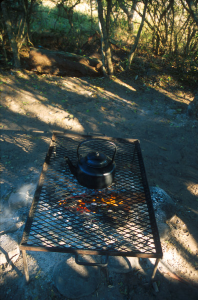 heating water in a kettle over a fire