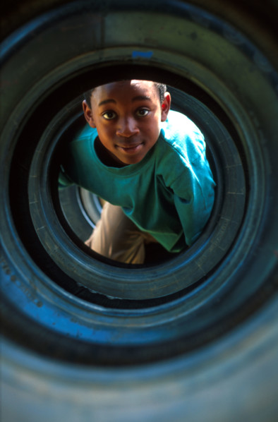 boy playing in a tyre