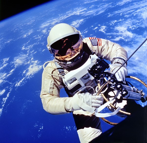Photograph showing US Astronaut Edward H. White II carrying out external tasks during third orbit of Gemini-Titan 4 flight