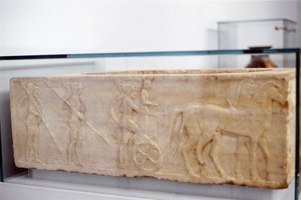 Ancient Greek warrior stepping into his chariot