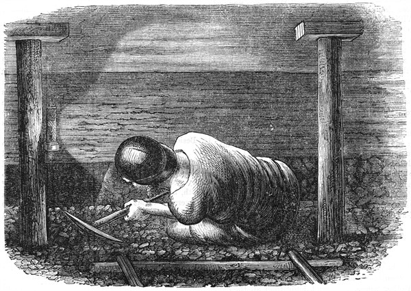 Miner working a seam with a pick 'scuffling' out the coal