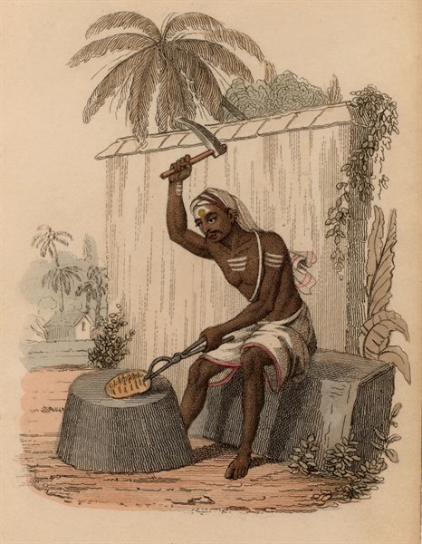 India : brazier beginning work on hammering a piece of brass into shape