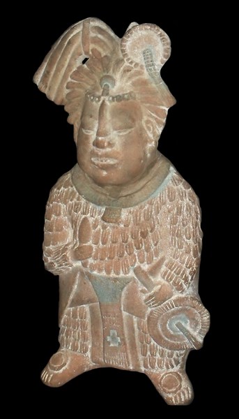 Mayan priest holding a knife and a fan
