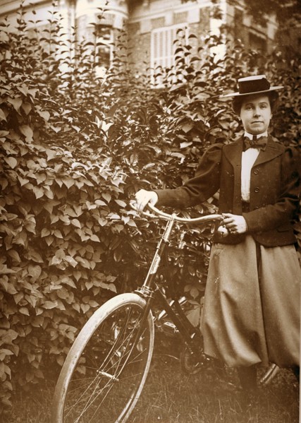 French woman standing with a bicycle