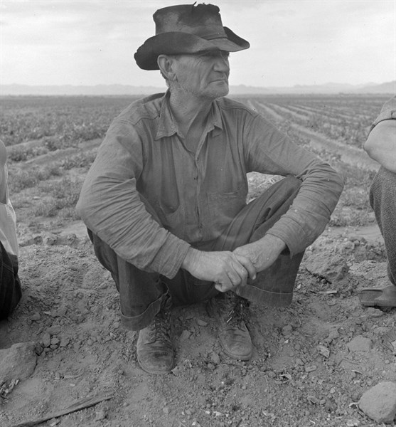 Migrant worker sitting in front of fire