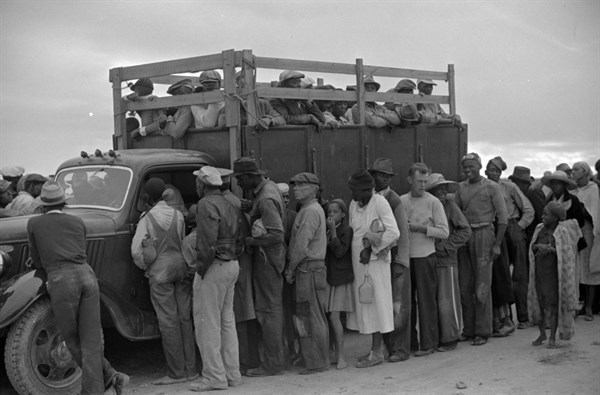 Vegetable workers, migrants, waiting after work to be paid. Near Homestead, Florida 19390101