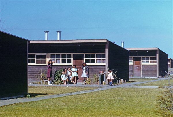 Families of migratory workers in front of their row shelters, 1942