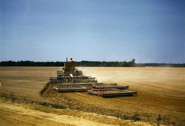 Harrowing a field with a diesel tractor USA 1942