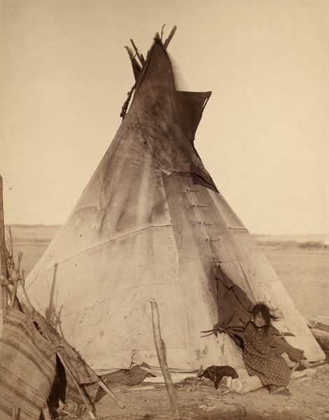 Photographic print of a young Oglala girl sitting in front of a Tipi