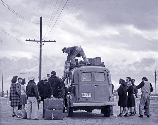 Photographic print of a loading bus leaving Manzanar for relocation