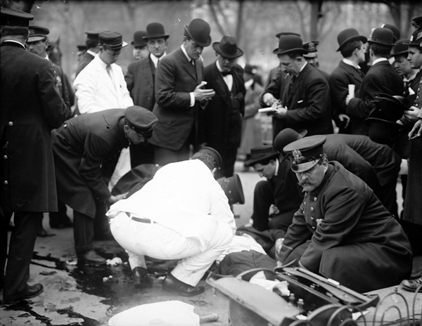 Surgeons and police working over Silverstein at anarchist riot, Union Square, New York.
