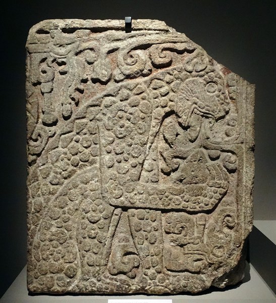 Mayan, calcified stone panel, with bas relief depicting a jaguar eating a heart.