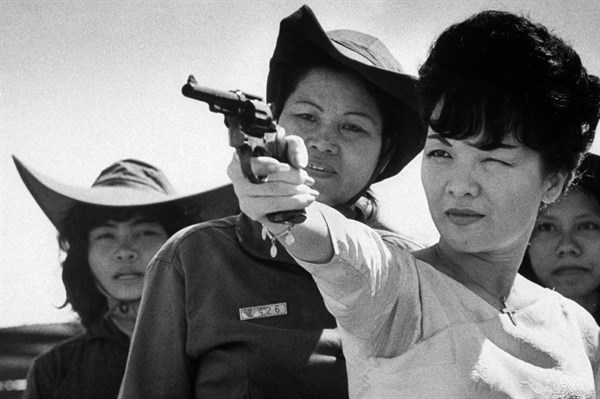 Photograph of Madame Nhu shooting a gun