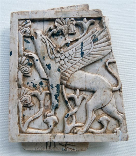 Ivory depicting a griffin eating leaves from a tree