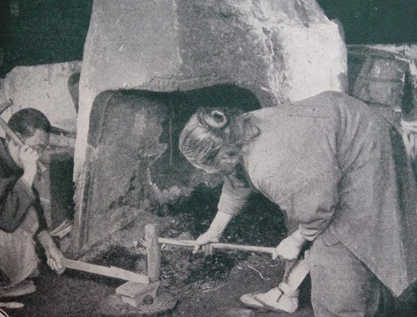 Japanese foundry showing husband and wife working at a forge. 1890