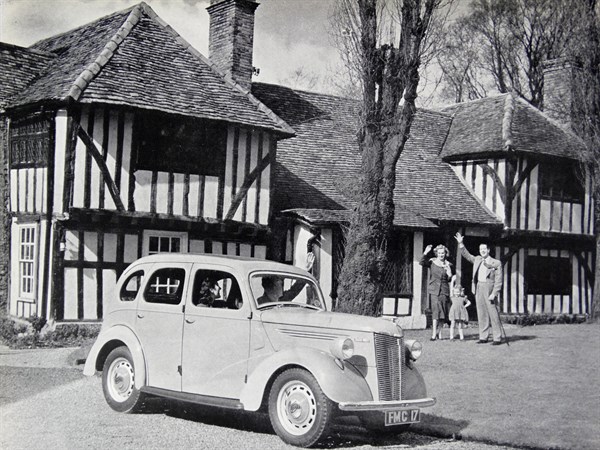 Photograph of a typical 1950s family outside of their home