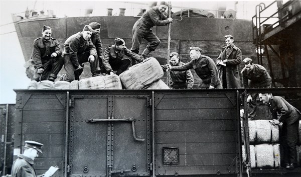 British soldiers load supplies at a railway depot in northern France, 1940