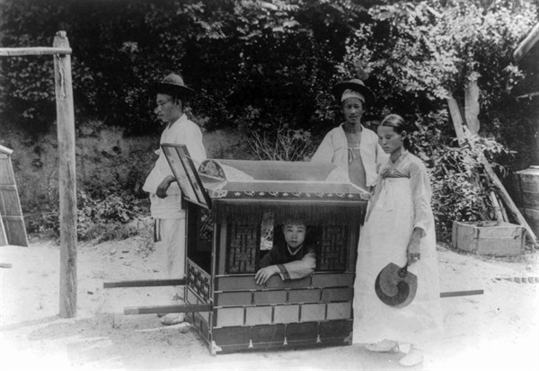 Korean noble boy carried by servants in a sedan chair 1900