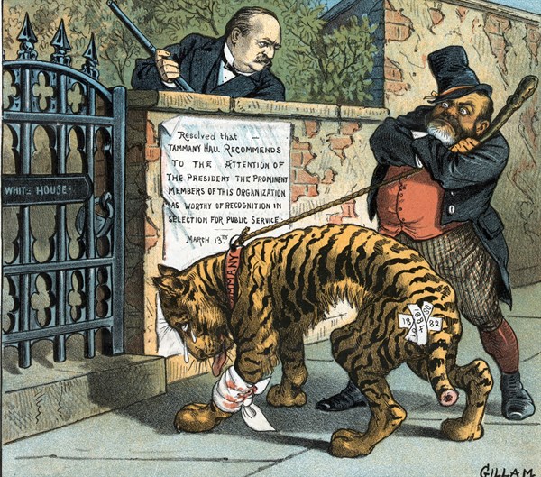 John Kelly holding a shillelagh in one hand and a rope tied to an injured tiger