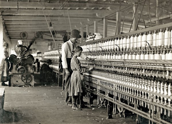Photograph of Young girl working as a spinner
