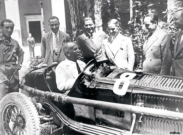 Mussolini sits in an Alfa Romeo racing car, 1934
