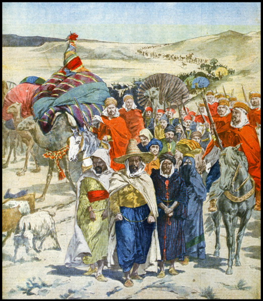 A Razzia or slave raid in caravan formation passing through the Algerian Sahara desert, 1900