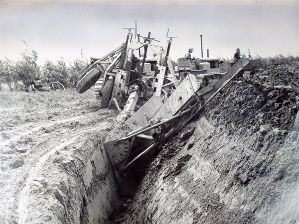 Photograph of a Dutch farmer construction a polder from land reclaimed for the sea bed