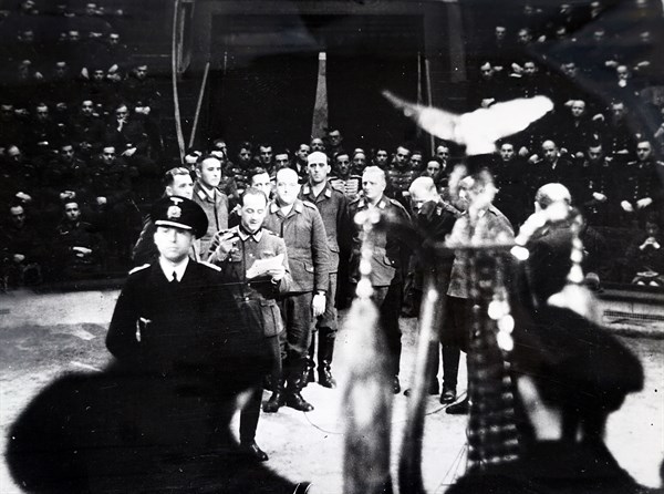 Photograph of Nazi soldiers singing at the start of a circus in Paris, during the German occupation of France, in World War Two