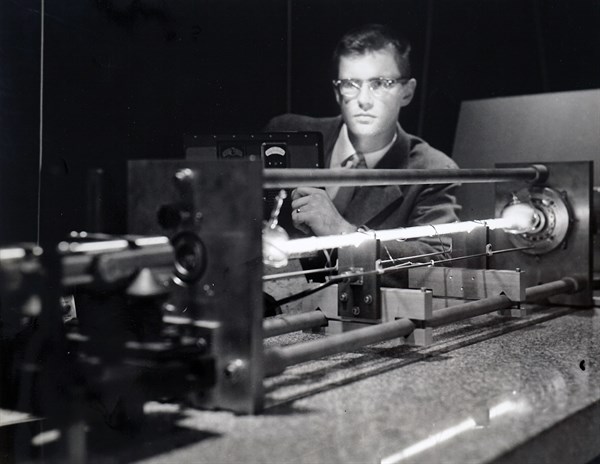 Photograph of a LASER FOR SPACE — Gas-filled electronic device whose first job will be to greatly sharpen the accuracy of a new space tracking radar is fired up by an engineer at Sperry Rand's Electro...