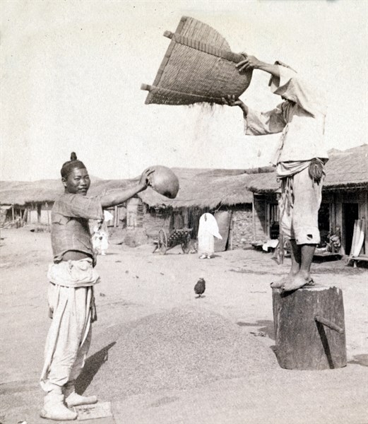 winnowing barley in the streets of Chemulop, Korea. Joseon Era