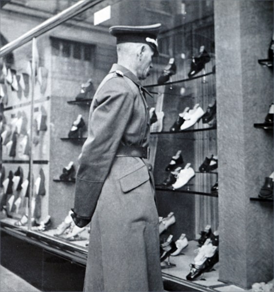 A German officer looks at the empty shops in Paris during World War II