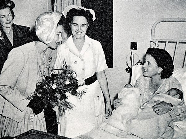 Admiring the twins of Mrs Harvey, wife of C.P.O. Harvey, of H.M.S. Chequers. Princess Elizabeth and Countess Mounbatten
