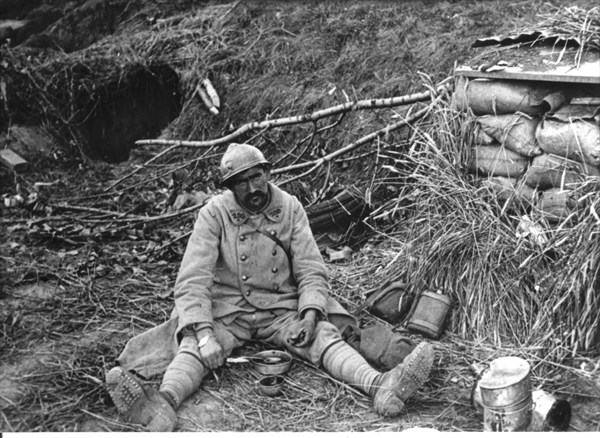 Soldier having lunch outside the shelters near Autheuil