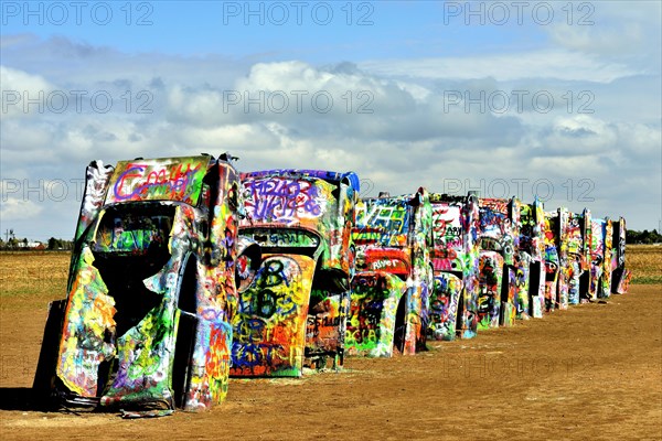 Painted Cadillacs rammed into the ground