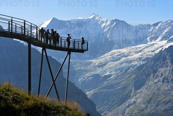 Tourists on the observation deck of the First Cliff Walk by Tissot in front of the Fiescherhorn north face and the Grindelwald glacier