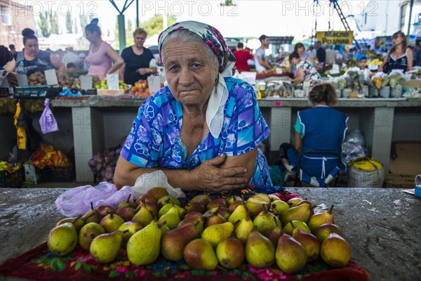 Woman selling apples on a local market