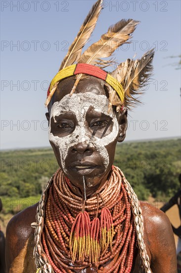 Woman with face painting and feather decoration