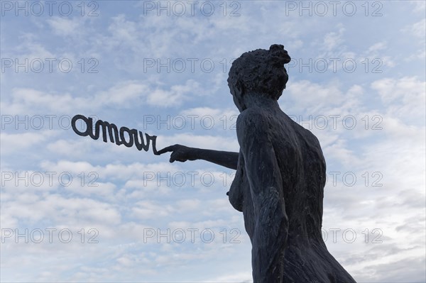 Woman writes French word Amour