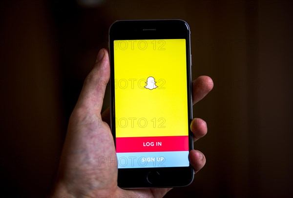 Hand holding iPhone with Snapchat App