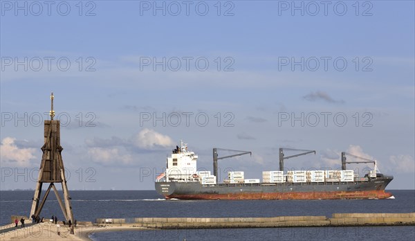 Kugelbake with freighter on the Elbe