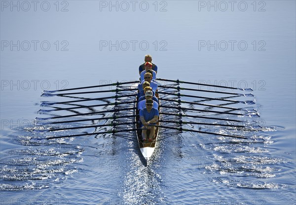 Rowers rowing in rowing boat