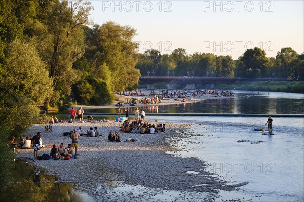 Teenagers on gravel bank at the riverside
