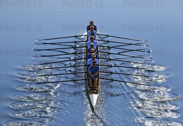 Rowers rowing in rowing boat