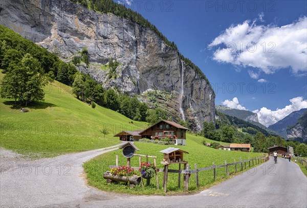 View of a farm house near Lauterbrunnen and with Staubbach Falls in the background