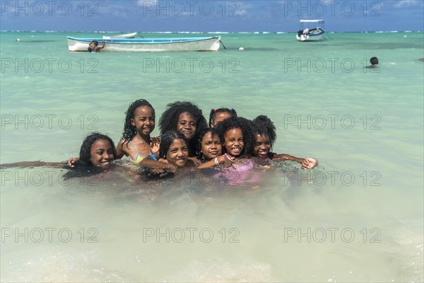 Local children bathing on the beach of Saint Francois