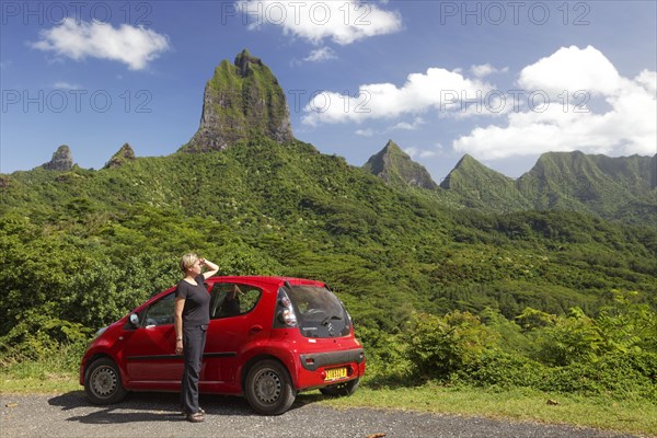 Woman with red car at Belvedere vantage point