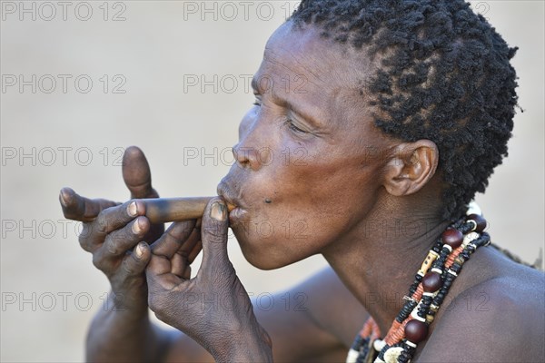 Old San woman smoking